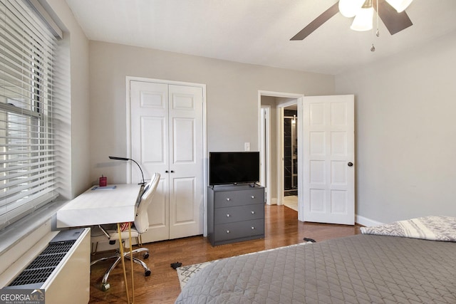300 W Peachtree St Unit 21K, Atlanta, GA 30305 - bedroom featuring dark wood-style floors, an office area, a closet, and a ceiling fan