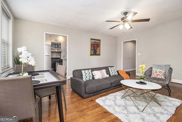 300 W Peachtree St Unit 21K, Atlanta, GA 30305 - living room with a ceiling fan and wood finished floors