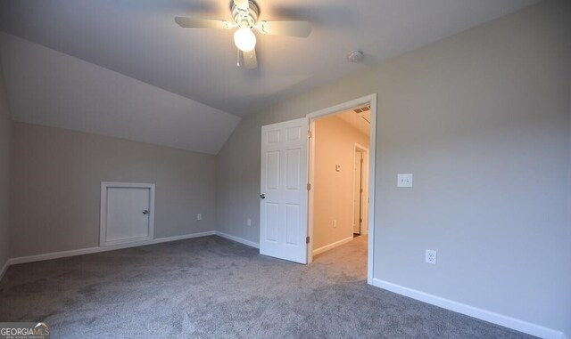additional living space with baseboards, vaulted ceiling, ceiling fan, and carpet