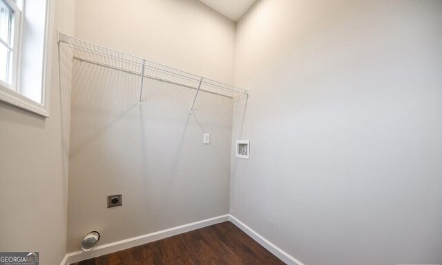 clothes washing area with washer hookup, baseboards, laundry area, dark wood-type flooring, and electric dryer hookup
