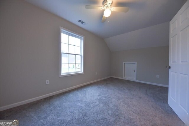 additional living space featuring visible vents, baseboards, ceiling fan, lofted ceiling, and carpet floors