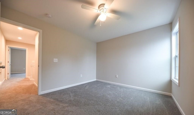 unfurnished bedroom with baseboards, multiple windows, ceiling fan, and carpet flooring