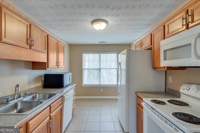 3024 Big Tree Rd, Gainesville, GA 30501 - kitchen with white appliances, a sink, light tile patterned floors, brown cabinetry, and light countertops