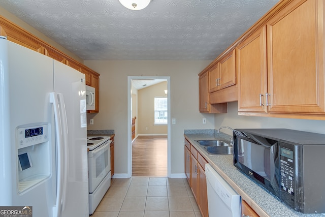 3024 Big Tree Rd, Gainesville, GA 30501 - kitchen featuring white appliances, a sink, baseboards, light tile patterned floors, and brown cabinets