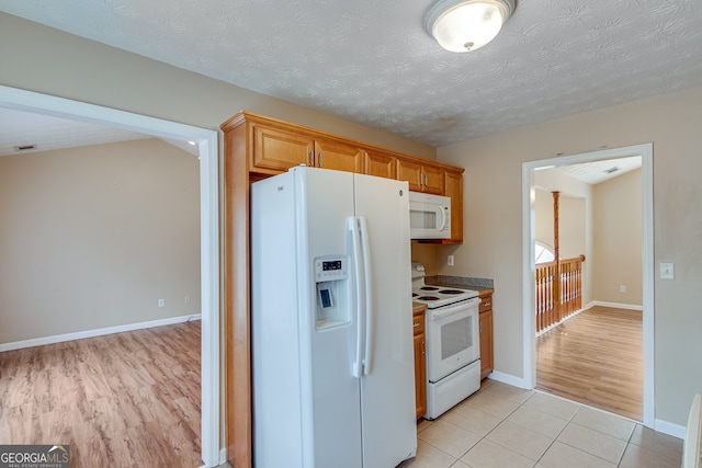3024 Big Tree Rd, Gainesville, GA 30501 - kitchen with white appliances, baseboards, light tile patterned flooring, and a textured ceiling