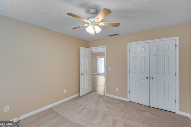 3024 Big Tree Rd, Gainesville, GA 30501 - unfurnished bedroom featuring baseboards, light colored carpet, a closet, a ceiling fan, and a textured ceiling