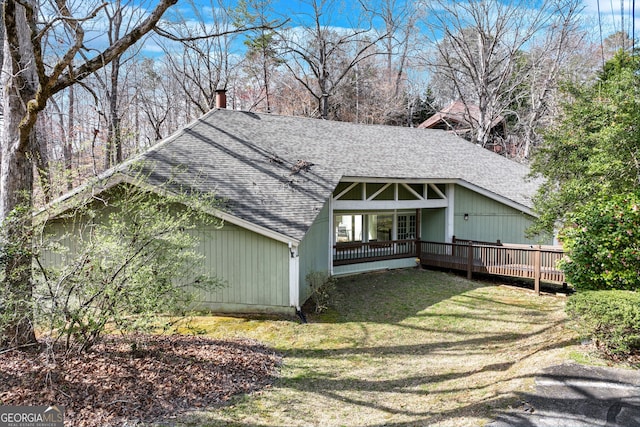 3024 Big Tree Rd, Gainesville, GA 30501 - back of house featuring a shingled roof, a chimney, a wooden deck, and a lawn
