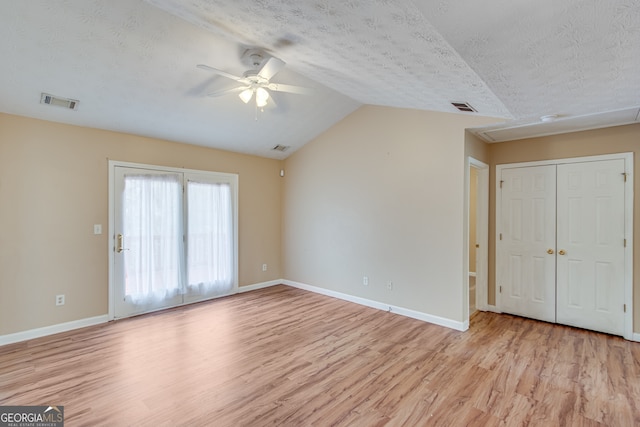 3024 Big Tree Rd, Gainesville, GA 30501 - unfurnished living room featuring light wood-style floors, ceiling fan, a textured ceiling, lofted ceiling, and baseboards