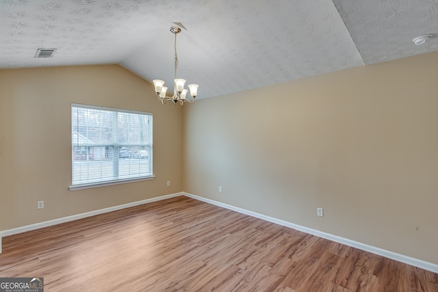 3024 Big Tree Rd, Gainesville, GA 30501 - unfurnished room featuring light wood-style floors, a chandelier, lofted ceiling, baseboards, and a textured ceiling