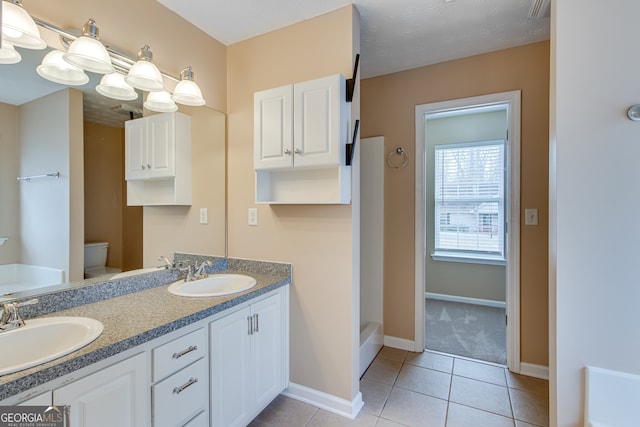 3024 Big Tree Rd, Gainesville, GA 30501 - bathroom featuring a tub, tile patterned flooring, double vanity, baseboards, and toilet