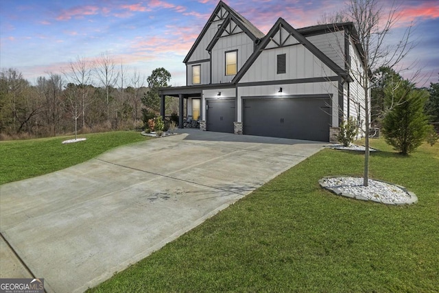 372 Garnet Dr, Acworth, GA 30101 - view of front of property with a garage, board and batten siding, a lawn, concrete driveway, and stone siding