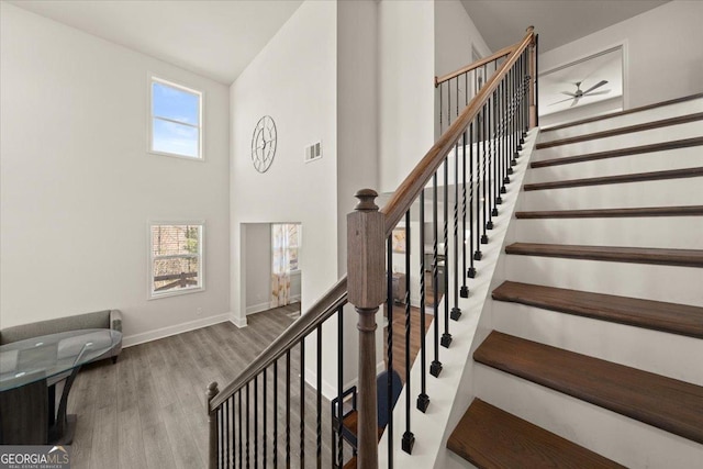 372 Garnet Dr, Acworth, GA 30101 - stairs featuring wood finished floors, baseboards, and a high ceiling
