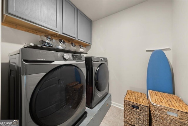 372 Garnet Dr, Acworth, GA 30101 - clothes washing area with cabinet space, washer and dryer, light tile patterned floors, and baseboards