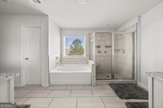 372 Garnet Dr, Acworth, GA 30101 - full bathroom with a shower stall, a bath, tile patterned flooring, and baseboards