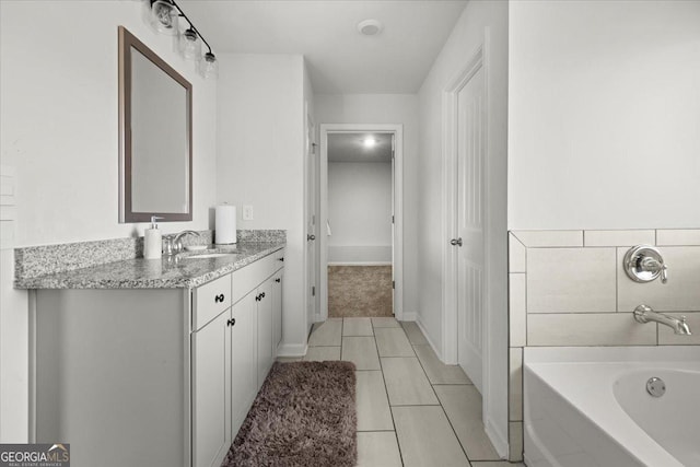 372 Garnet Dr, Acworth, GA 30101 - full bathroom with tile patterned floors, a bath, vanity, and baseboards