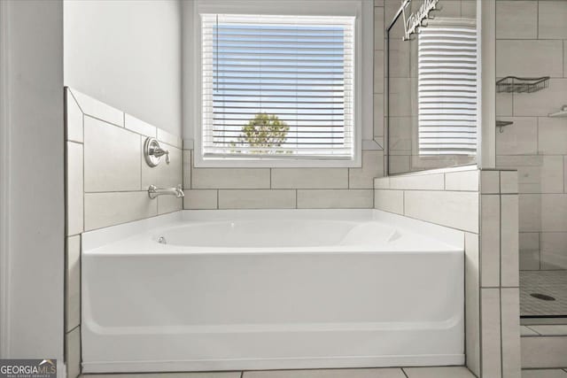 372 Garnet Dr, Acworth, GA 30101 - bathroom featuring plenty of natural light, a garden tub, and a stall shower