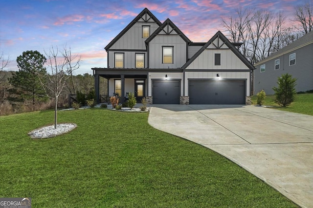 372 Garnet Dr, Acworth, GA 30101 - view of front of house featuring board and batten siding, concrete driveway, a yard, a garage, and a porch