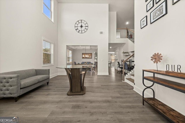 372 Garnet Dr, Acworth, GA 30101 - entrance foyer featuring stairs, a towering ceiling, healthy amount of natural light, dark wood-style flooring, and baseboards