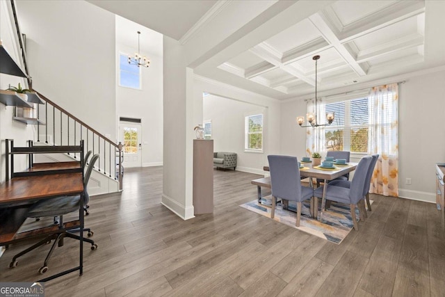 372 Garnet Dr, Acworth, GA 30101 - dining room with a chandelier, stairs, wood finished floors, beam ceiling, and baseboards