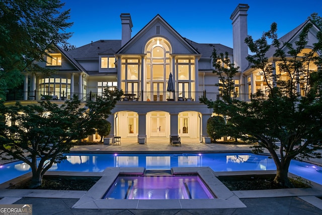 510 Covington Cv, Alpharetta, GA 30022 - back of house with a balcony, an in-ground hot tub, a patio, a chimney, and an outdoor pool