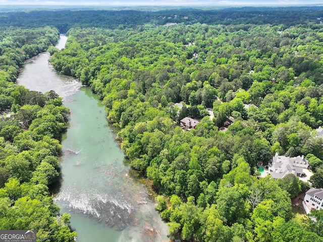 bird's eye view featuring a forest view and a water view