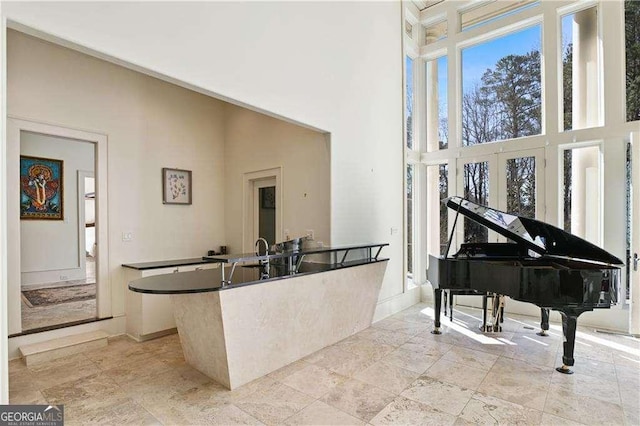 510 Covington Cv, Alpharetta, GA 30022 - sitting room with a towering ceiling, baseboards, and light stone finish floors