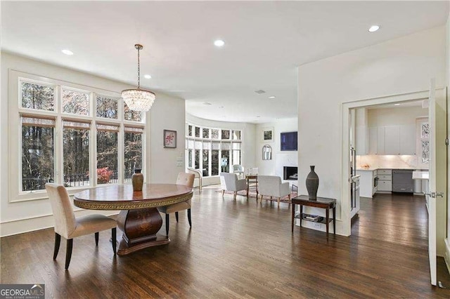 dining area with an inviting chandelier, recessed lighting, and dark wood-type flooring