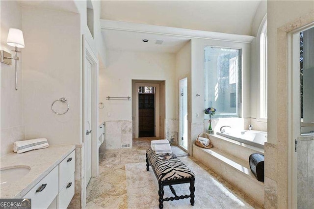 full bathroom with vanity, a shower stall, and a bath