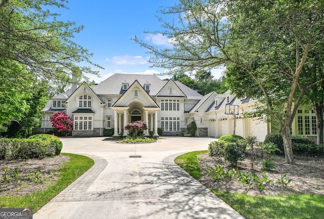 510 Covington Cv, Alpharetta, GA 30022 - french country inspired facade with stone siding, curved driveway, and an attached garage