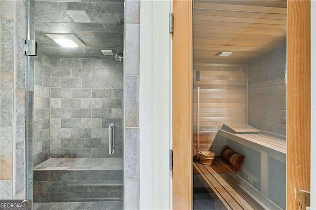 full bathroom featuring a shower stall, wood ceiling, and a sauna