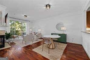 unfurnished dining area featuring a multi sided fireplace and wood finished floors