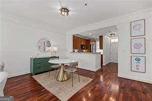 unfurnished dining area featuring baseboards and wood finished floors