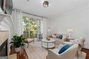 living room featuring crown molding and wood finished floors