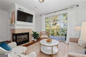 living area with wood finished floors and a fireplace