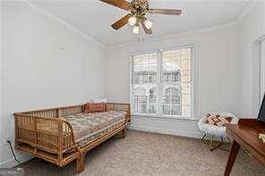 carpeted bedroom featuring lofted ceiling and ornamental molding