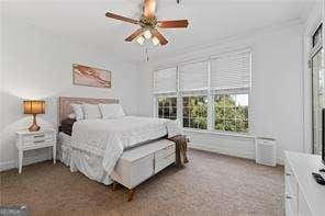 bedroom with a ceiling fan and carpet floors