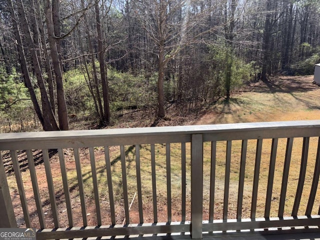 wooden deck featuring a forest view