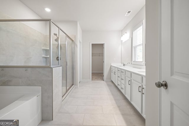 119 Peachwood Ln, Homer, GA 30547 - full bath featuring a stall shower, double vanity, a garden tub, a walk in closet, and recessed lighting