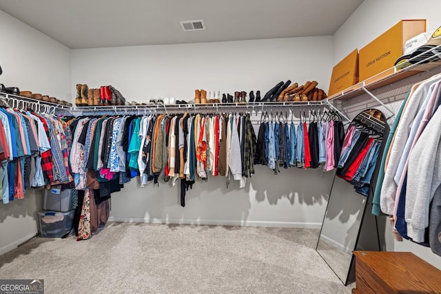 walk in closet featuring carpet flooring and visible vents