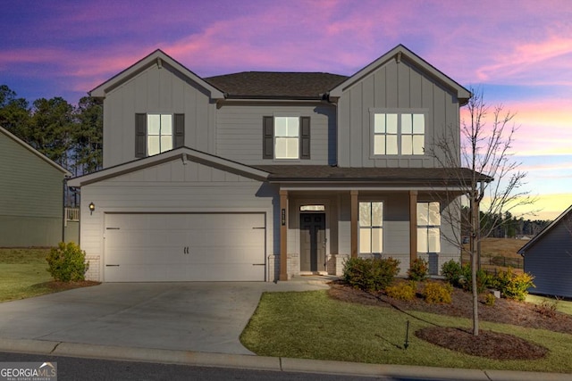 traditional-style house featuring covered porch, driveway, a garage, and board and batten siding