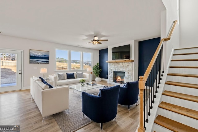 119 Peachwood Ln, Homer, GA 30547 - living room featuring a ceiling fan, stairway, baseboards, light wood-style floors, and a fireplace