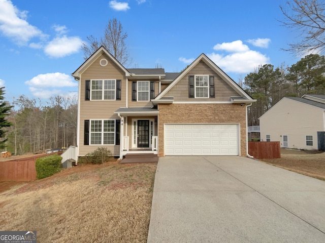 traditional-style house with driveway, an attached garage, a front yard, and fence