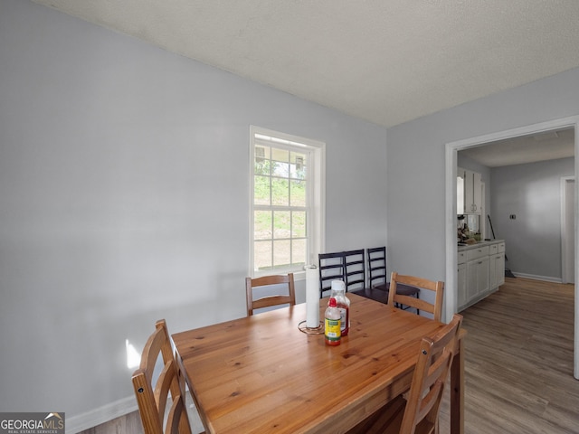 dining room featuring baseboards and wood finished floors