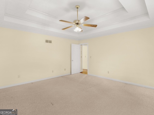230 Acorn Ct, Mcdonough, GA 30253 - unfurnished room featuring a raised ceiling, ceiling fan, light colored carpet, baseboards, and ornamental molding