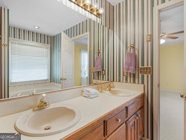 230 Acorn Ct, Mcdonough, GA 30253 - full bath featuring double vanity, wallpapered walls, a garden tub, baseboards, and ceiling fan