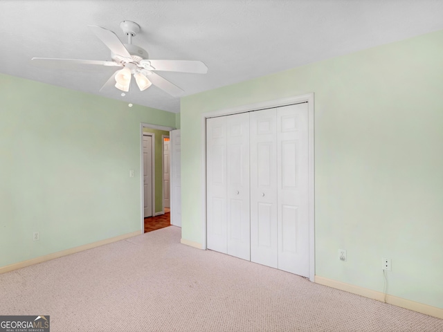 230 Acorn Ct, Mcdonough, GA 30253 - unfurnished bedroom featuring carpet flooring, baseboards, a closet, and a ceiling fan