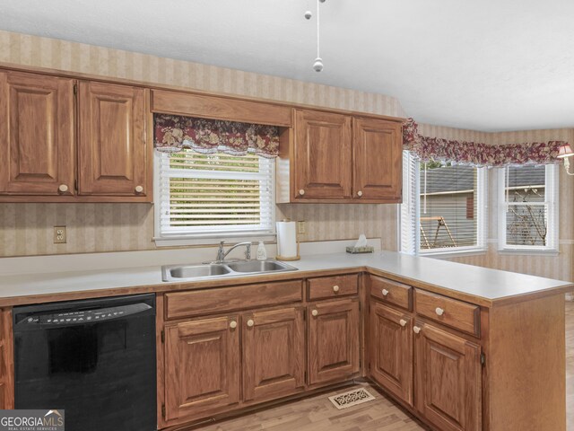230 Acorn Ct, Mcdonough, GA 30253 - kitchen with black dishwasher, a sink, a peninsula, light countertops, and wallpapered walls