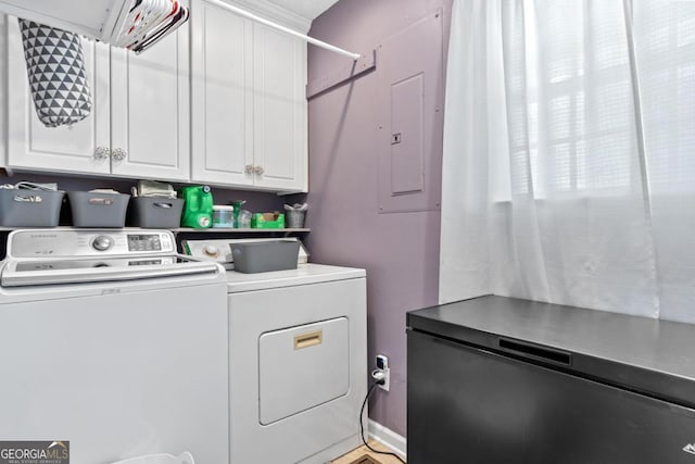 laundry area with washer and clothes dryer and cabinet space