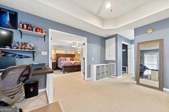 bedroom featuring baseboards, ceiling fan, visible vents, and light colored carpet