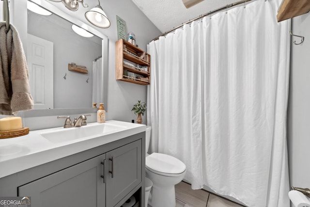 full bathroom with toilet, vanity, a textured ceiling, and a shower with shower curtain